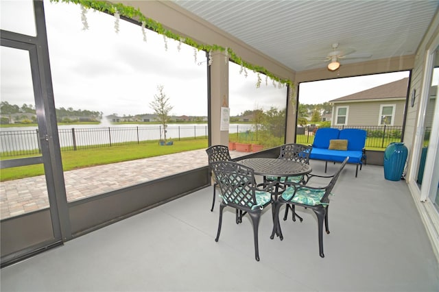 sunroom featuring ceiling fan