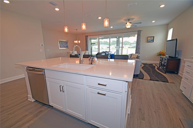 kitchen with a kitchen island with sink, dishwasher, sink, ceiling fan, and white cabinets