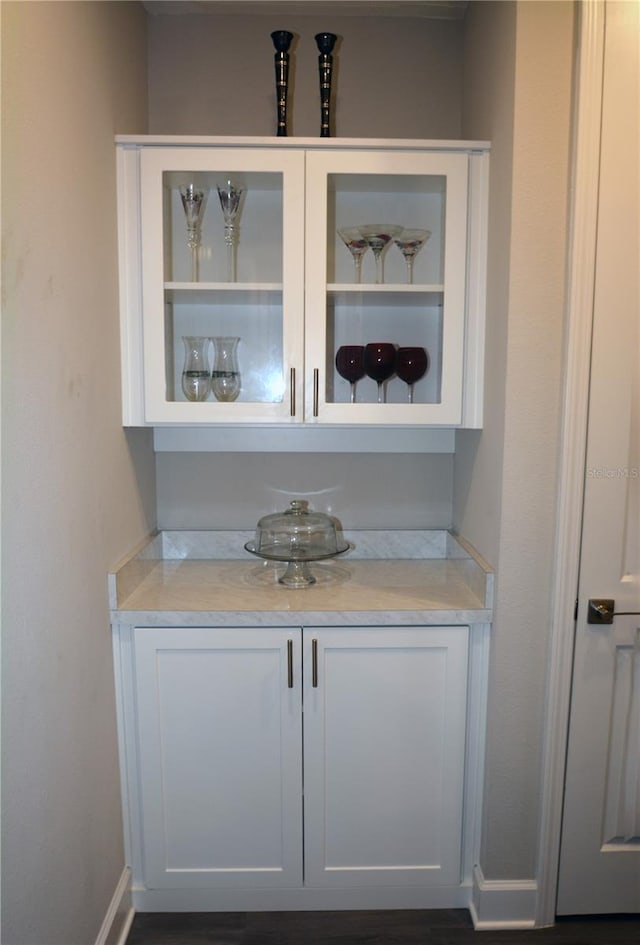 bar featuring white cabinets