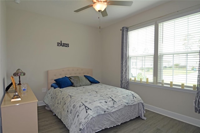 bedroom featuring dark hardwood / wood-style flooring and ceiling fan