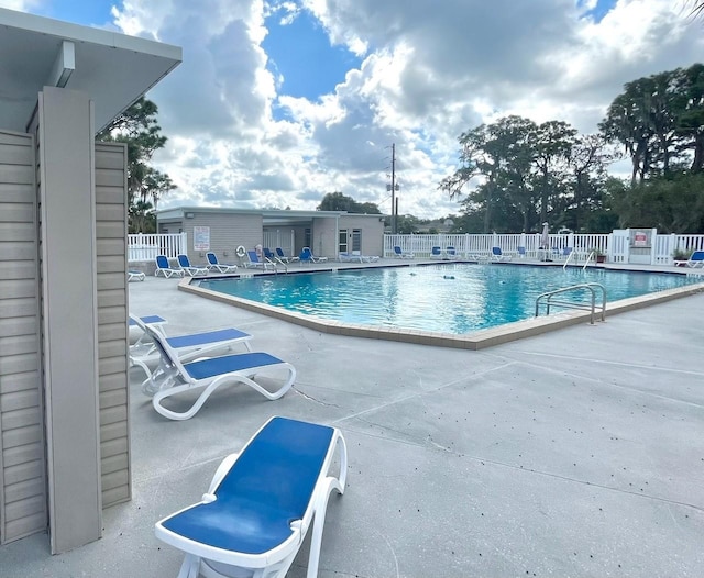 pool featuring a patio and fence