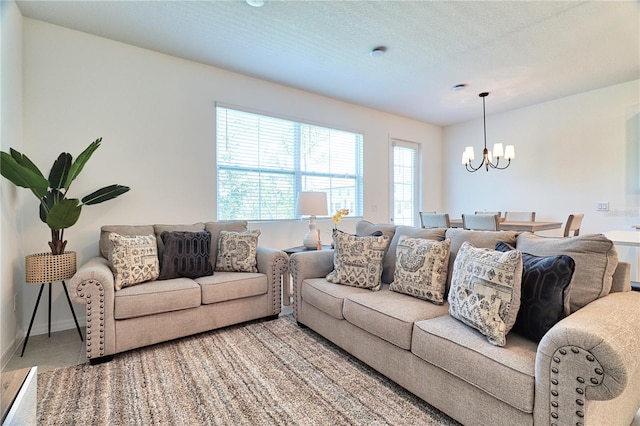 living room featuring a textured ceiling and a notable chandelier