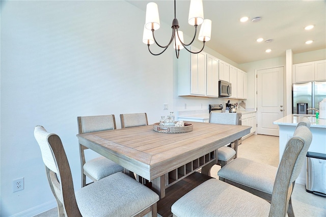 dining space with an inviting chandelier and sink