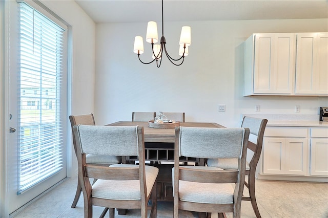 dining space with an inviting chandelier and a healthy amount of sunlight