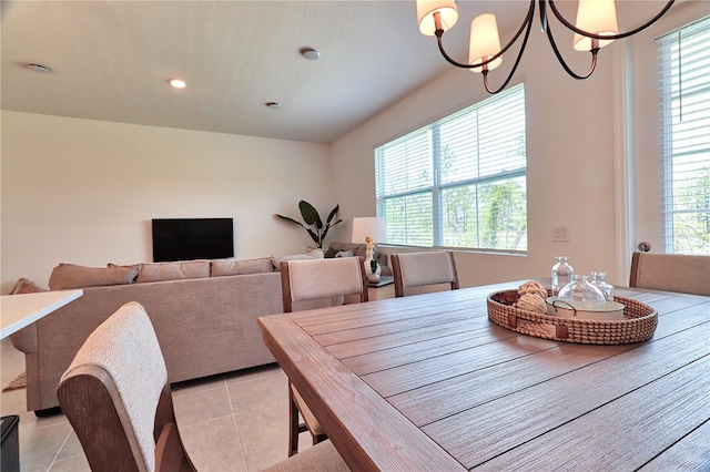 dining room with light tile patterned floors, a notable chandelier, and a textured ceiling