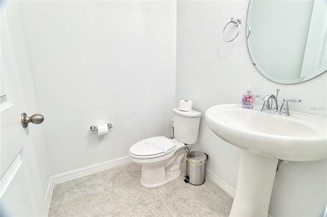 bathroom with toilet and tile patterned flooring