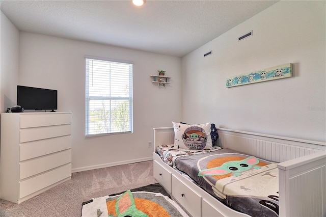 carpeted bedroom featuring a textured ceiling