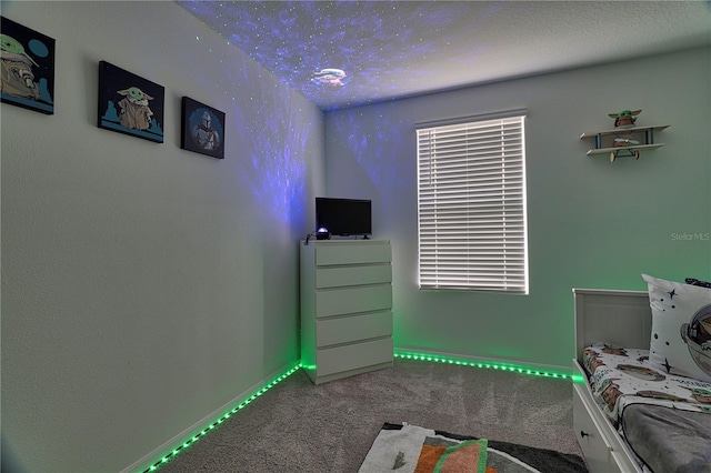 carpeted bedroom featuring a textured ceiling