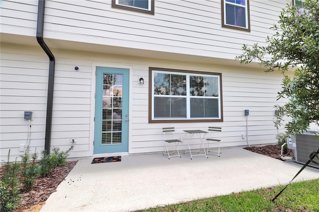 doorway to property with a patio area and cooling unit