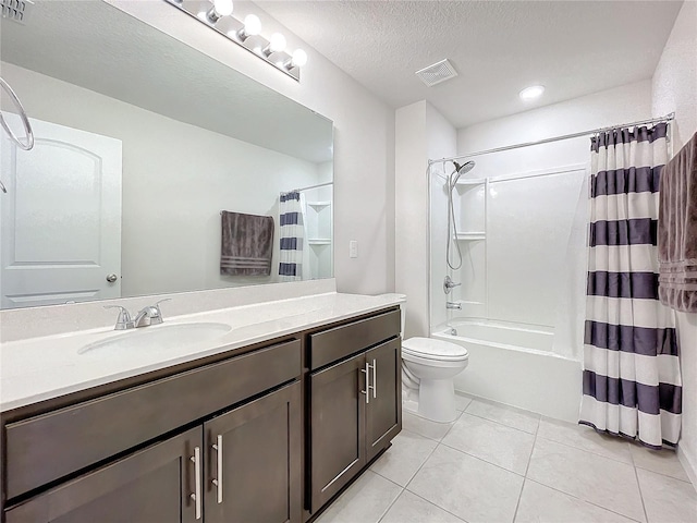 full bathroom featuring toilet, vanity, tile patterned flooring, shower / bath combination with curtain, and a textured ceiling