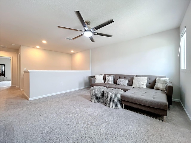 living room featuring ceiling fan and light colored carpet