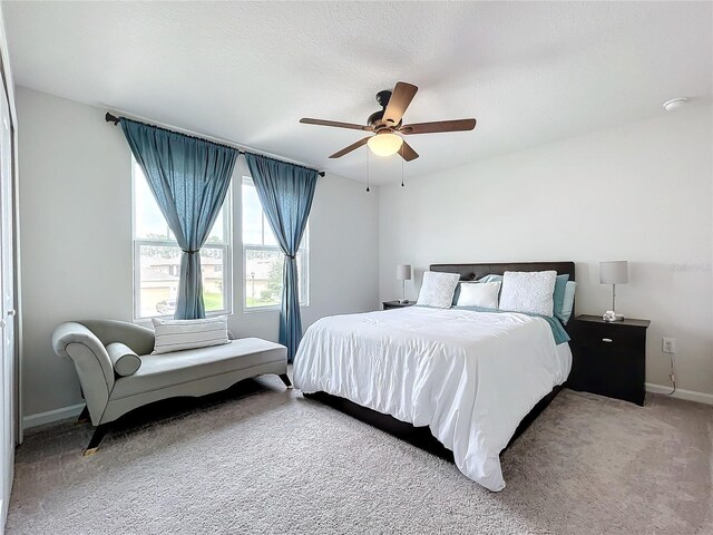 bedroom with ceiling fan and carpet floors