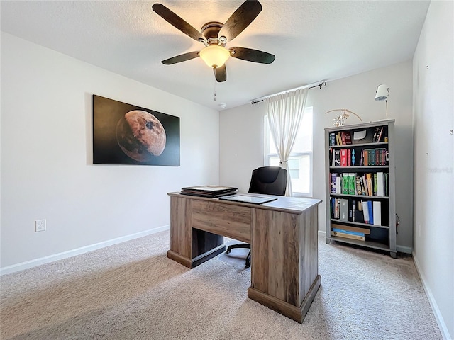 office featuring ceiling fan and light carpet