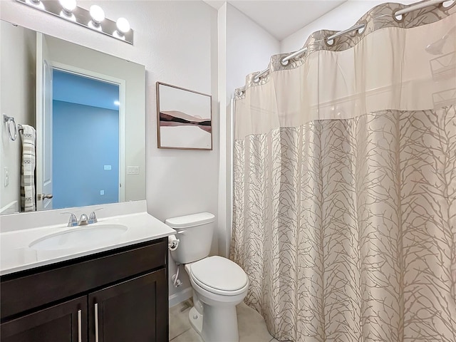 bathroom featuring toilet, a shower with shower curtain, tile patterned flooring, and vanity