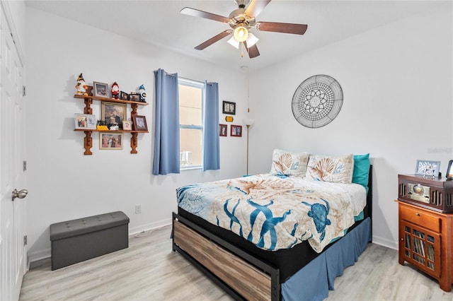 bedroom with ceiling fan and light wood-type flooring