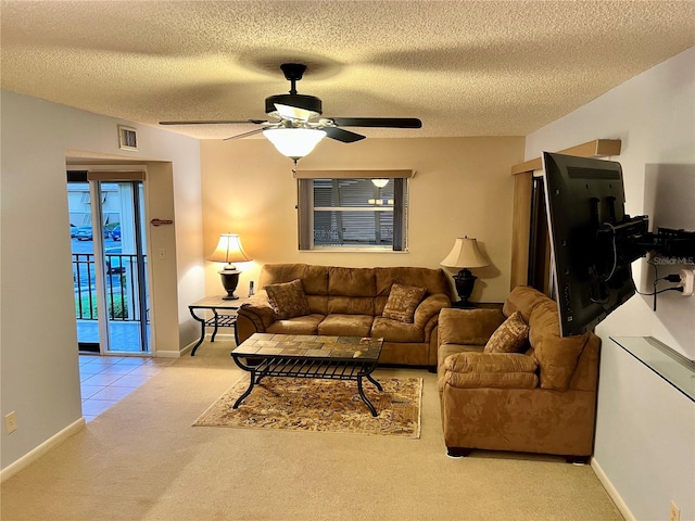 living room with light carpet, a textured ceiling, and ceiling fan