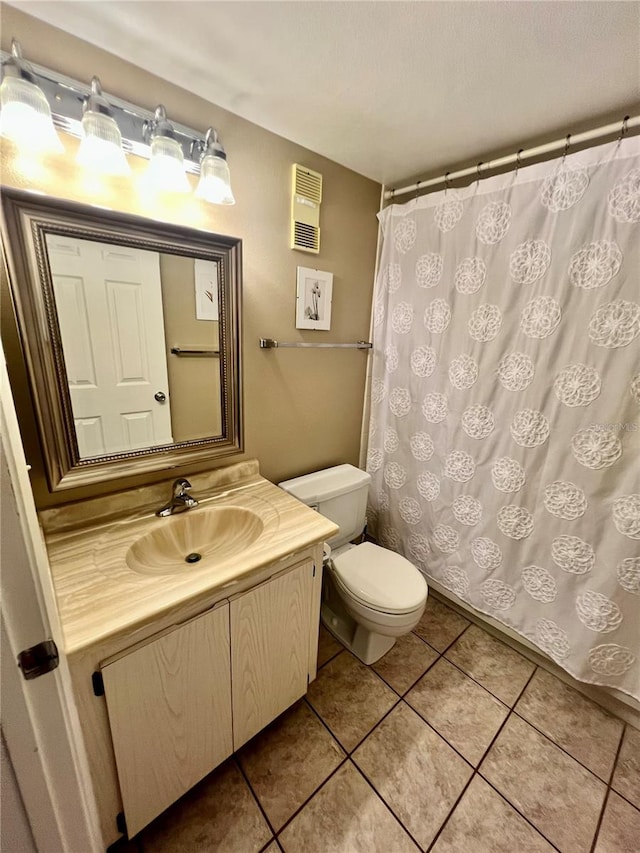 bathroom featuring vanity, toilet, tile patterned floors, and walk in shower