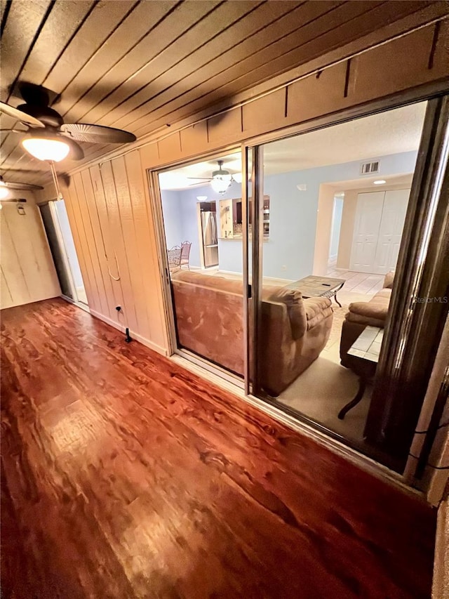 hall with wood ceiling, wood-type flooring, and wood walls