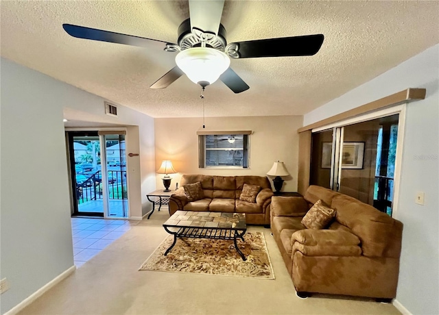 living room featuring a textured ceiling and ceiling fan