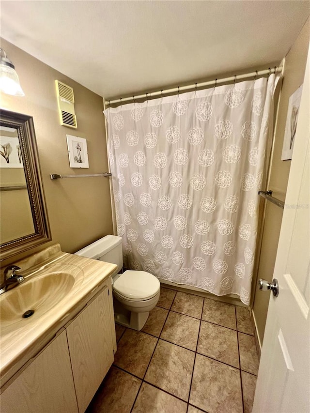 bathroom featuring tile patterned floors, a shower with shower curtain, toilet, and vanity