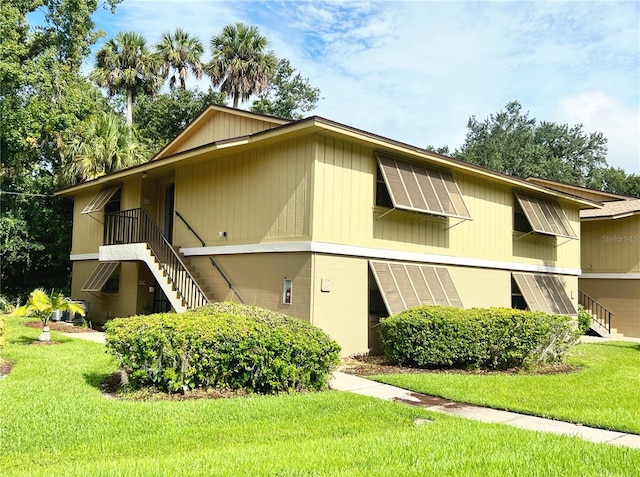 view of side of home with a lawn