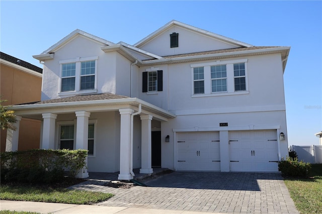 view of front of property featuring covered porch and a garage