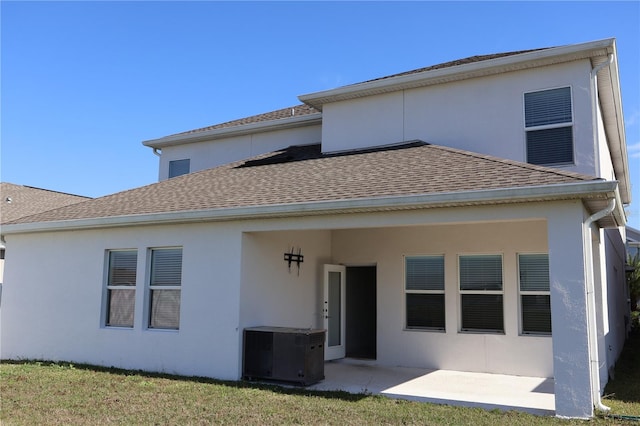 back of property featuring a yard and a patio area