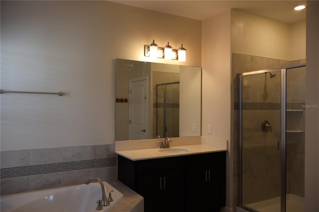 bathroom featuring vanity and separate shower and tub