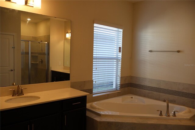 bathroom with independent shower and bath and vanity