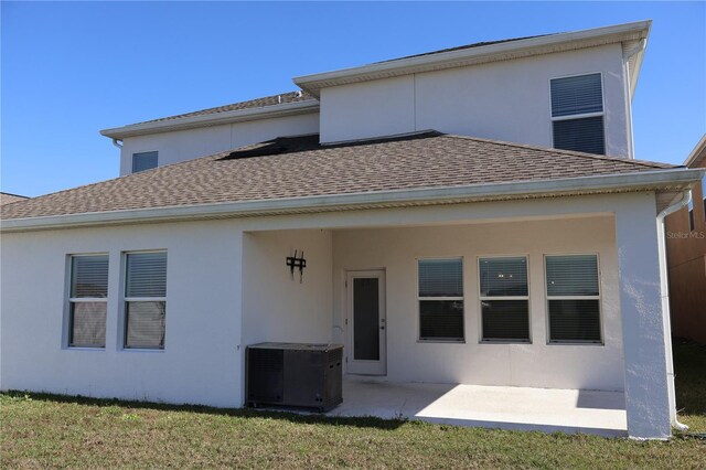 rear view of property with a yard and a patio