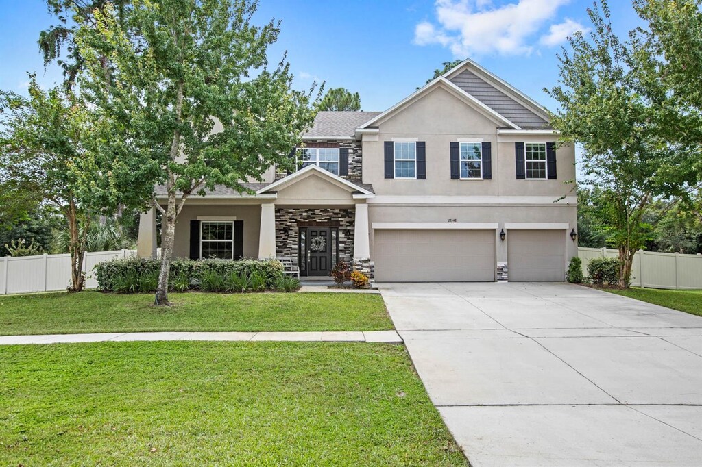 craftsman-style house featuring a front lawn and a garage