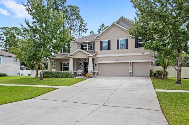 craftsman inspired home with a garage and a front yard