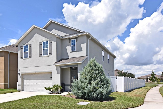 view of front of house with a garage and a front lawn