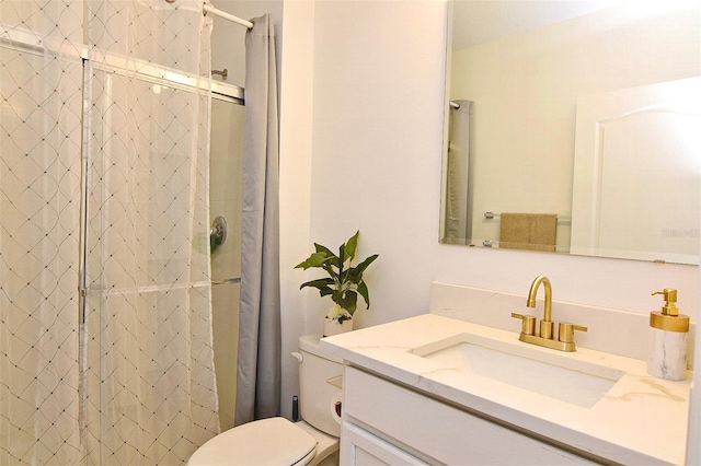 bathroom with a shower, vanity, and toilet