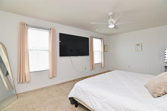 bedroom featuring carpet flooring, multiple windows, and ceiling fan