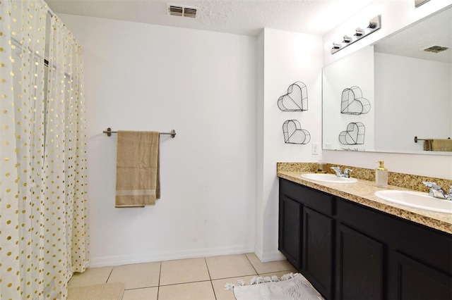 bathroom featuring tile patterned flooring, vanity, a textured ceiling, and a shower with shower curtain