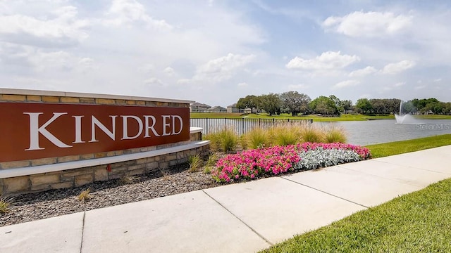 community / neighborhood sign with a water view