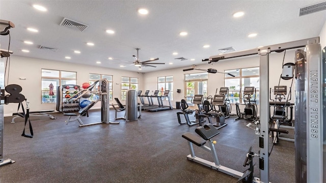 exercise room featuring ceiling fan and a textured ceiling