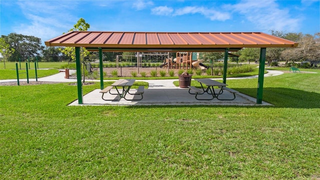 view of property's community featuring a playground, a lawn, and a gazebo