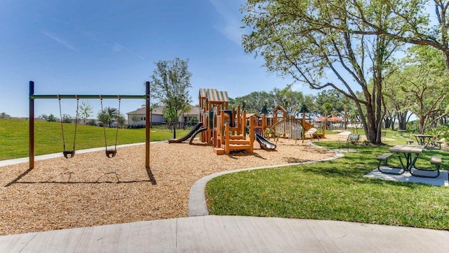 view of playground with a lawn