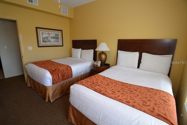 bedroom with dark colored carpet