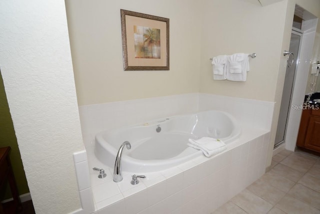 bathroom featuring separate shower and tub and tile patterned flooring