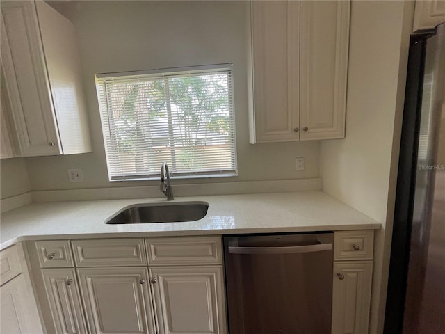 kitchen with white cabinets, appliances with stainless steel finishes, and sink