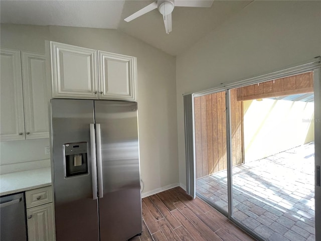 kitchen with white cabinets, vaulted ceiling, appliances with stainless steel finishes, dark hardwood / wood-style floors, and ceiling fan