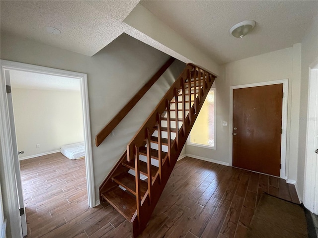 foyer with a textured ceiling and hardwood / wood-style floors