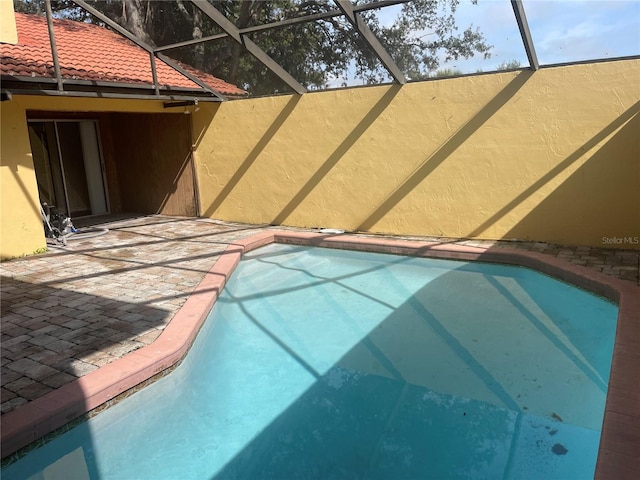 view of pool featuring a lanai and a patio