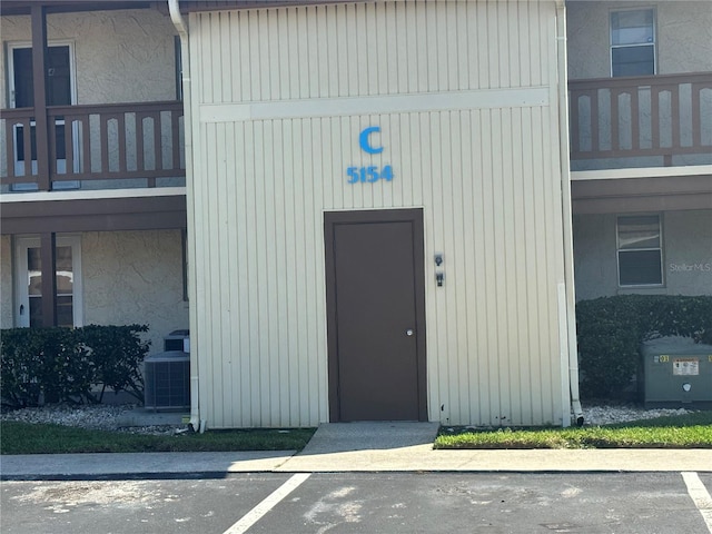 doorway to property featuring a balcony and cooling unit