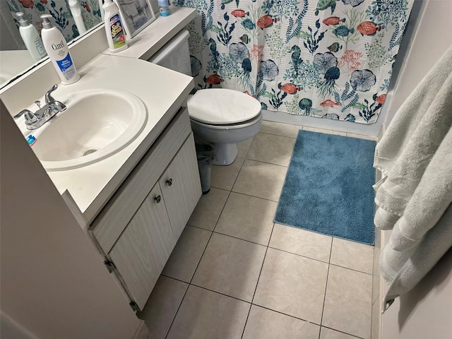 bathroom featuring vanity, toilet, a shower with shower curtain, and tile patterned flooring