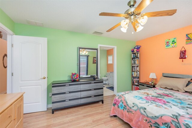 715 Unabelle Ave, Daytona Beach, FL 32117 - bedroom featuring ensuite bath, ceiling fan, and light hardwood / wood-style flooring