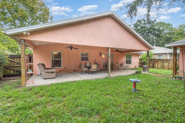 715 Unabelle Ave, Daytona Beach, FL 32117 - back of house featuring ceiling fan, a patio area, and a yard